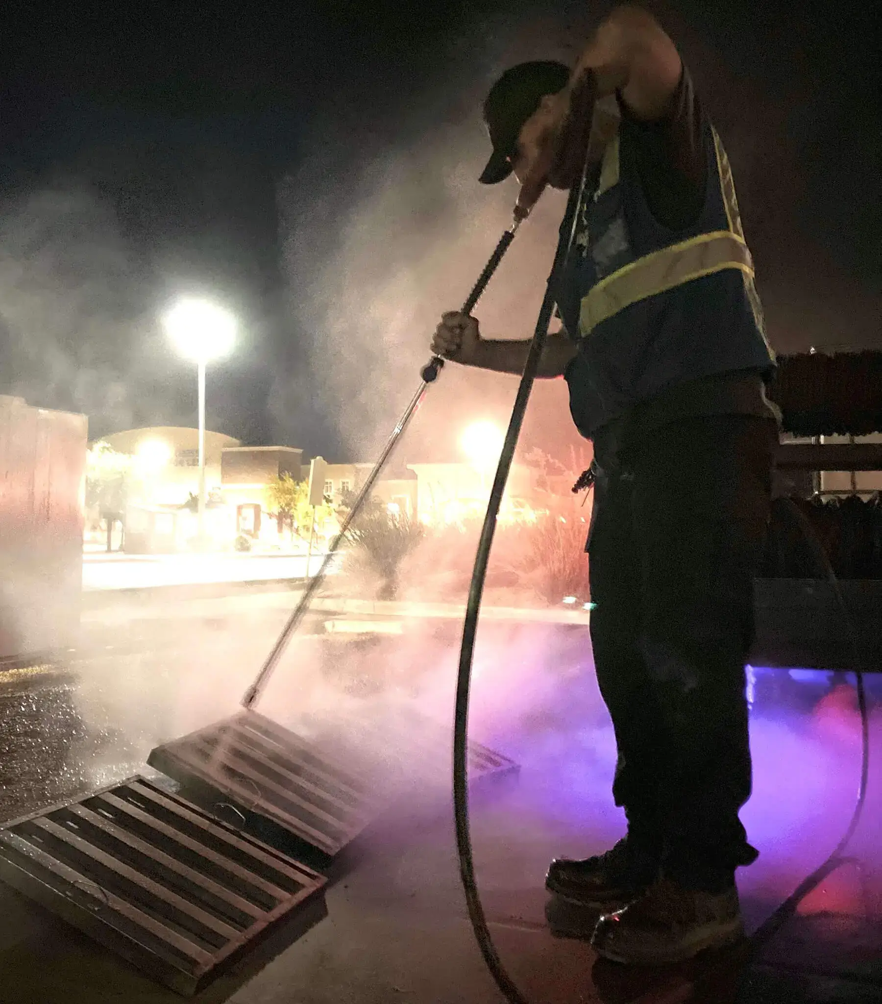 A commercial pressure washing professional cleaning a large surface area using AI-driven dispatching and operational software for scaling routes.