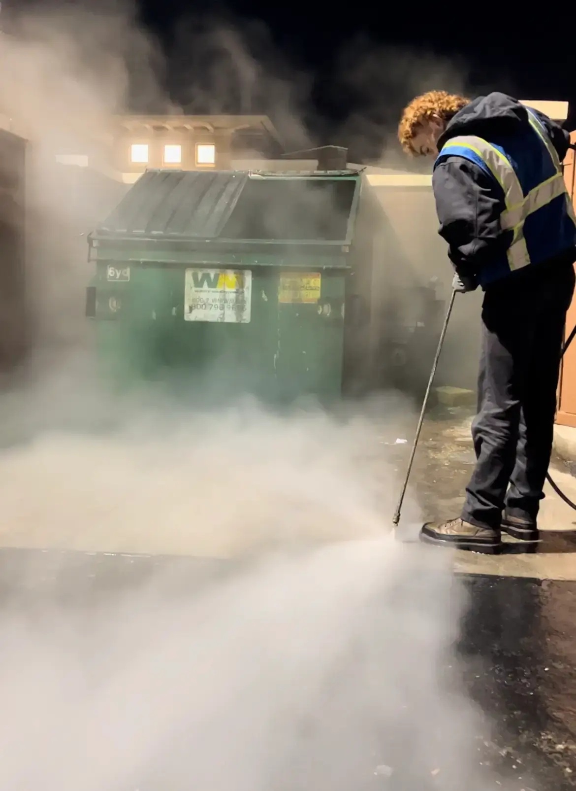 Professional pressure washing technician using AI voice-to-text and scanning tools for field operations and automated business management.